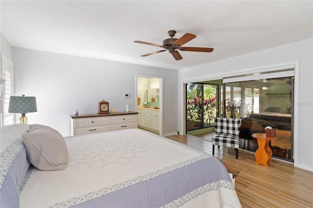 bedroom featuring ceiling fan, multiple windows, and ensuite bath