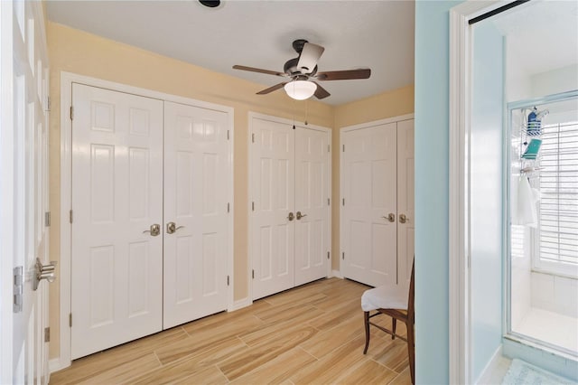 bedroom featuring two closets and ceiling fan