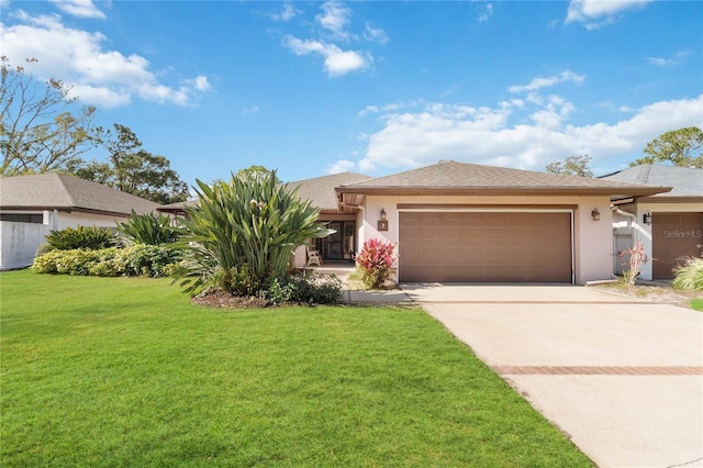 view of front of house featuring a garage and a front lawn