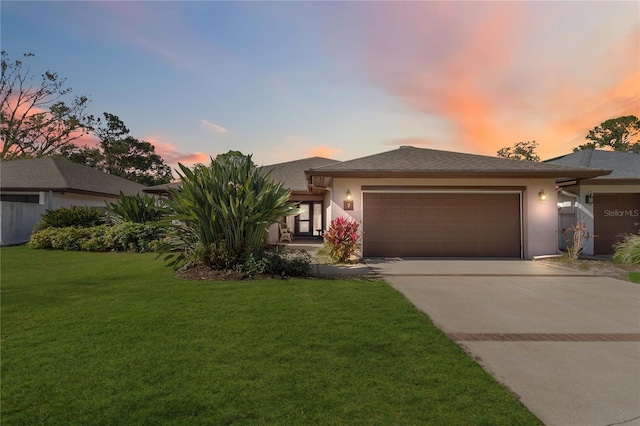 7 Huntley Ct, Haines City, FL 33844 - view of front of house featuring a garage, stucco siding, concrete driveway, and a front yard
