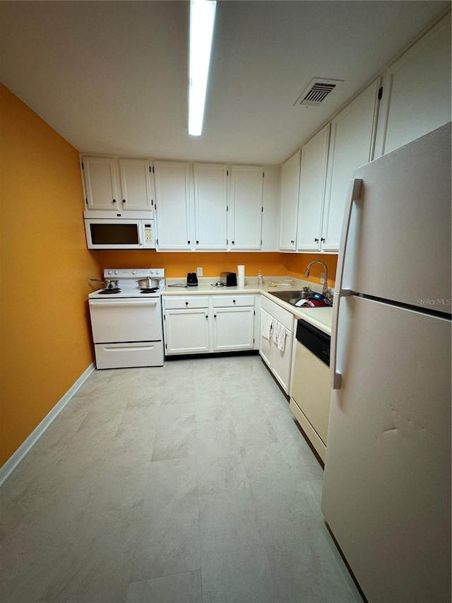 kitchen featuring white cabinetry, white appliances, and sink