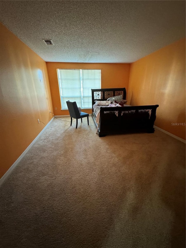 carpeted bedroom with a textured ceiling