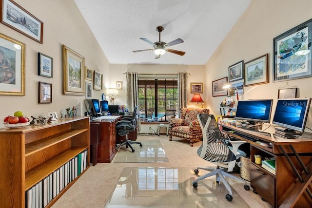 office with a textured ceiling, ceiling fan, light colored carpet, and vaulted ceiling