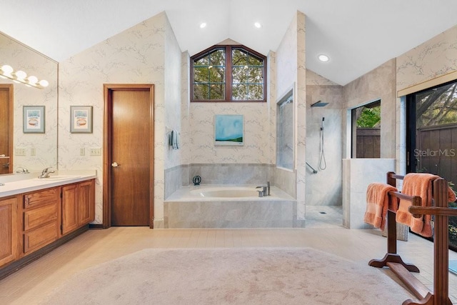 bathroom featuring vanity, vaulted ceiling, and shower with separate bathtub