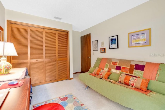 bedroom with light carpet and a closet