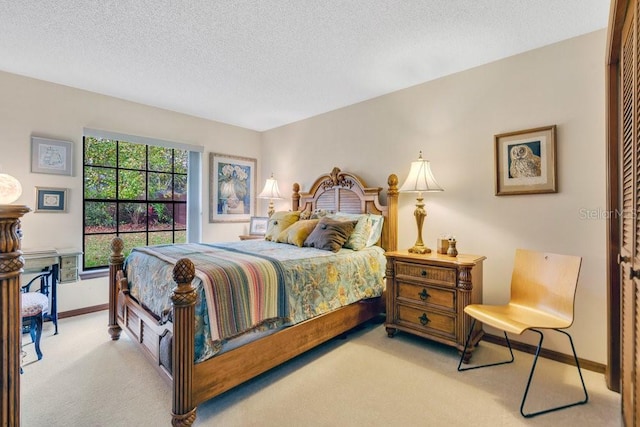 carpeted bedroom featuring a textured ceiling