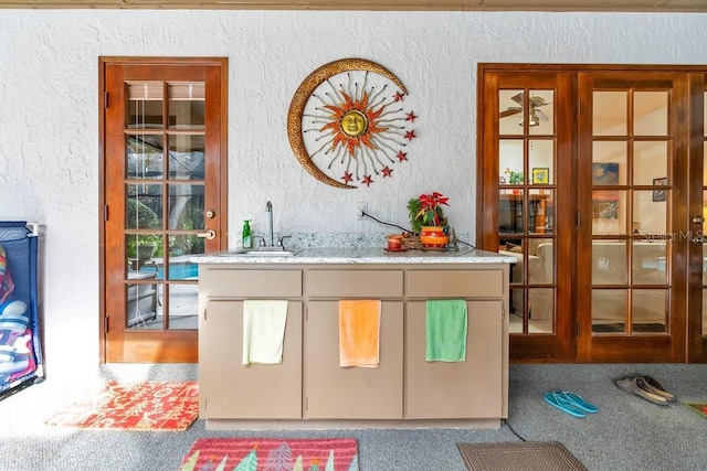 bar with light colored carpet and sink