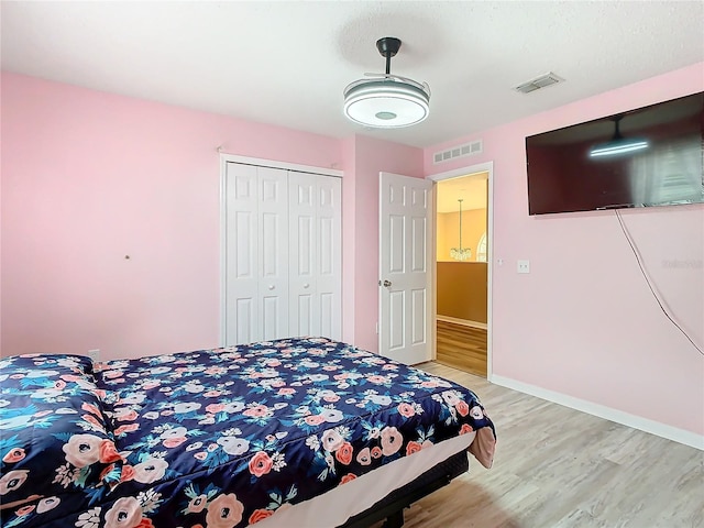 bedroom featuring light hardwood / wood-style floors and a closet