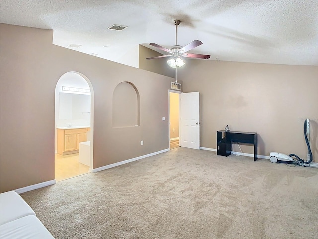 interior space featuring carpet flooring, a textured ceiling, ceiling fan, and lofted ceiling