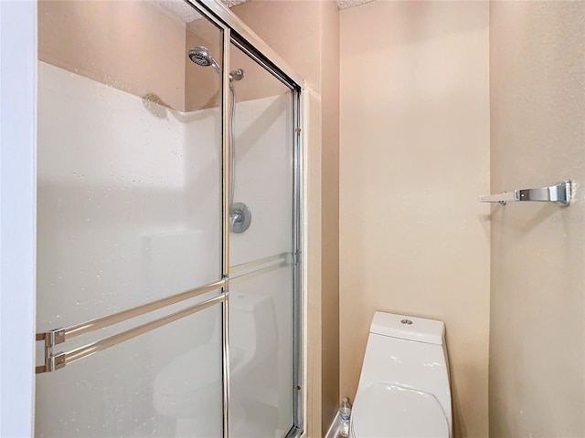 bathroom with toilet and walk in shower