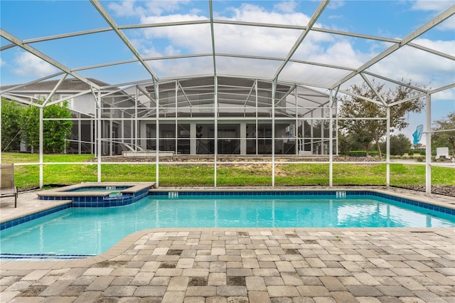 view of swimming pool with glass enclosure, an in ground hot tub, and a patio