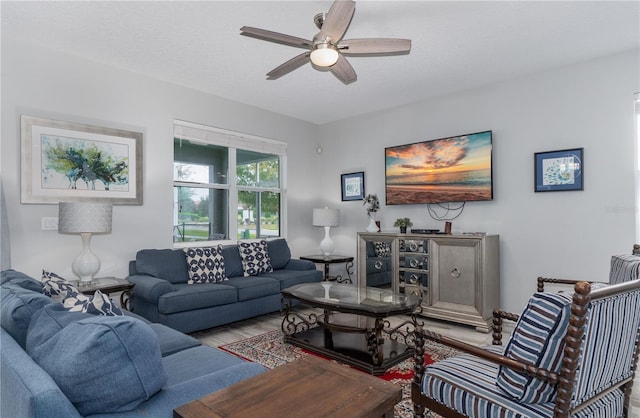 living room with ceiling fan and a textured ceiling