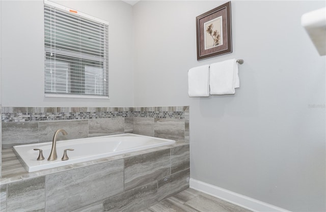 bathroom with a relaxing tiled tub