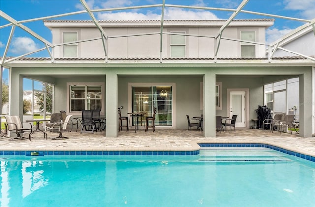 back of house with a patio area and a lanai