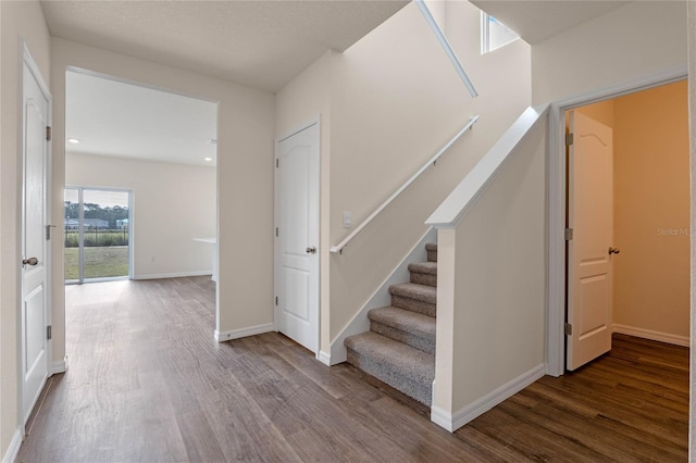 staircase with wood-type flooring