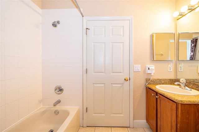 bathroom featuring tile patterned flooring, vanity, and tiled shower / bath