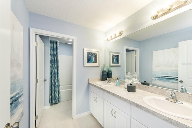 bathroom featuring shower / tub combo, tile patterned flooring, vanity, and a textured ceiling