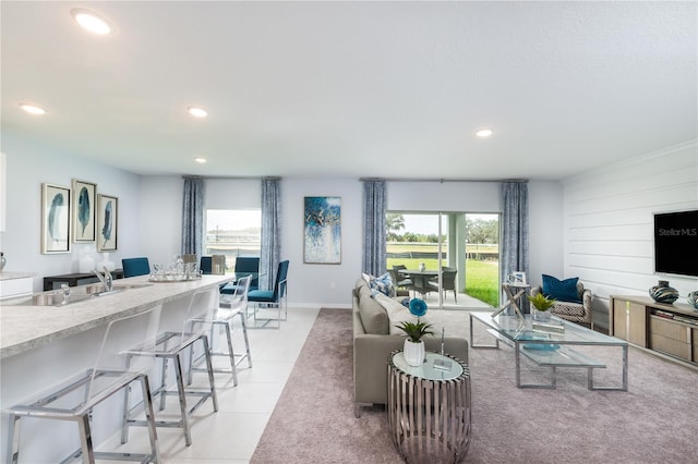 living room with light tile patterned floors and sink