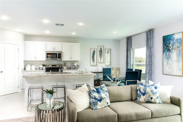 tiled living room featuring sink