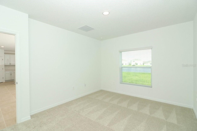 unfurnished room with light carpet