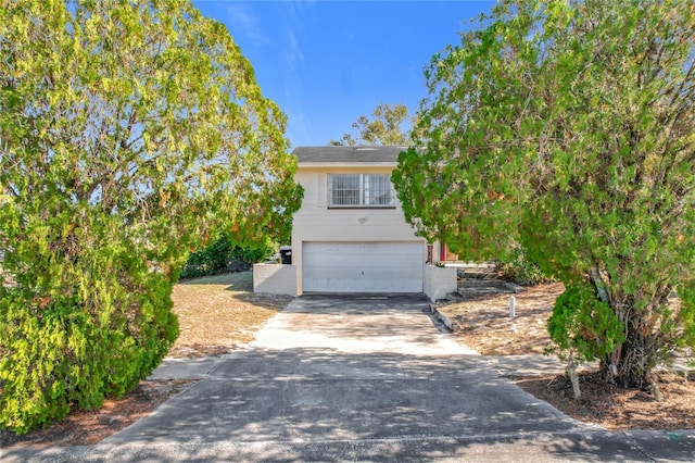 obstructed view of property featuring a garage