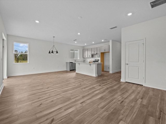 unfurnished living room with light wood-type flooring