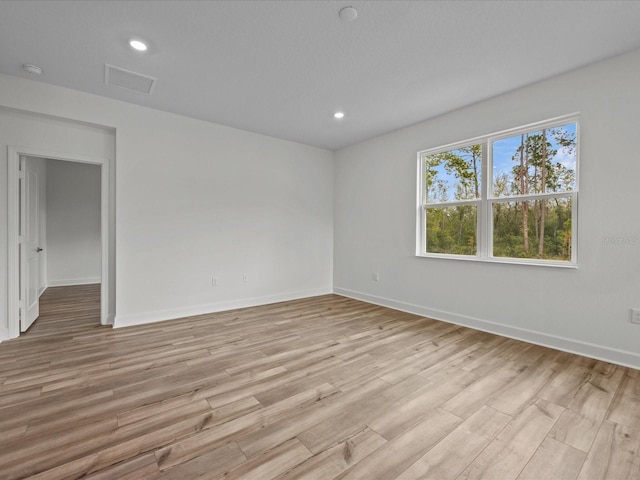 unfurnished room featuring light hardwood / wood-style floors