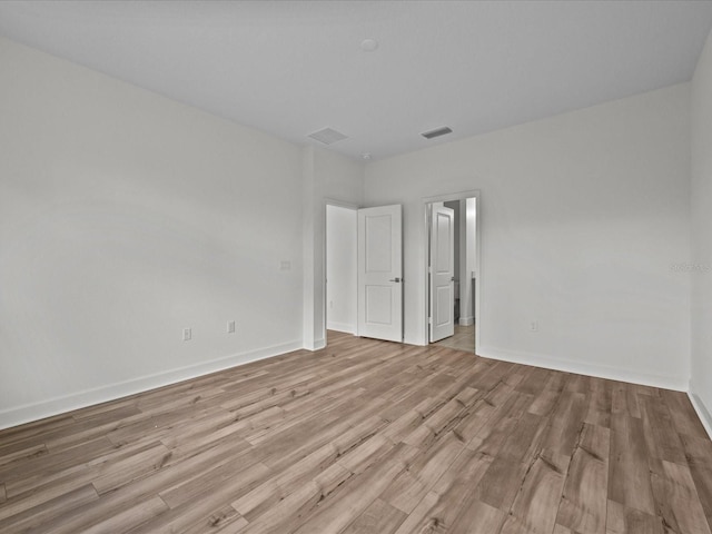 empty room with light hardwood / wood-style flooring