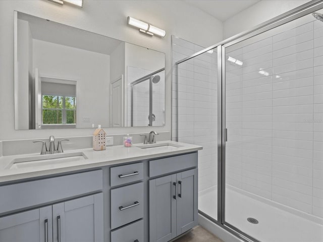 bathroom featuring vanity and a shower with shower door