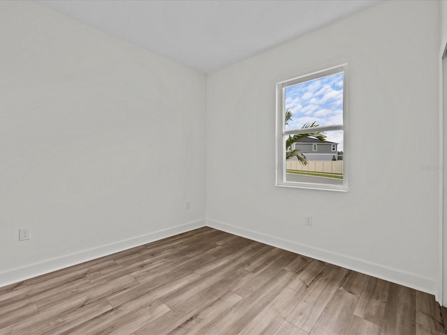 empty room with light hardwood / wood-style flooring