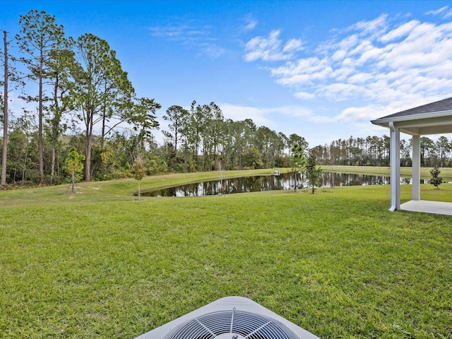 view of yard with cooling unit and a water view