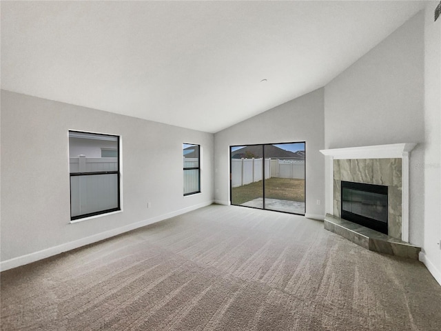 unfurnished living room with carpet, lofted ceiling, and a fireplace