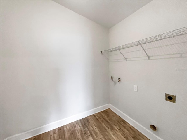 laundry room with electric dryer hookup and hardwood / wood-style flooring