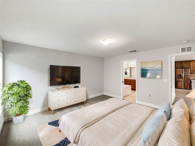 carpeted bedroom featuring connected bathroom and stainless steel refrigerator with ice dispenser