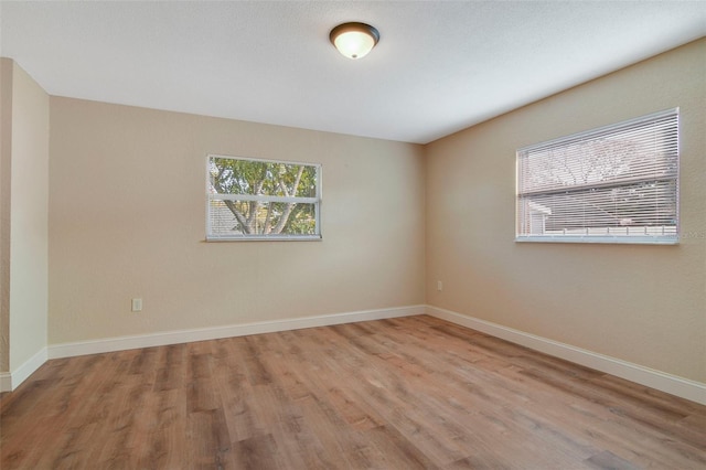 unfurnished room with light hardwood / wood-style floors