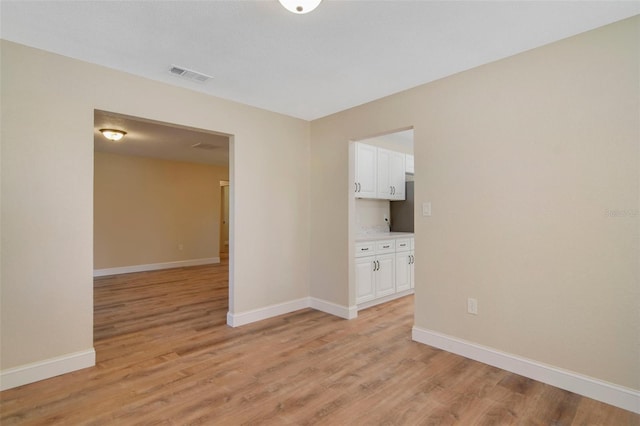 unfurnished room with light hardwood / wood-style floors