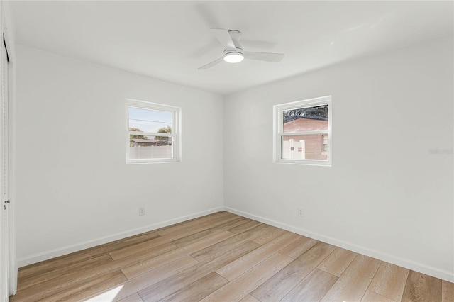 spare room featuring light wood-type flooring and ceiling fan