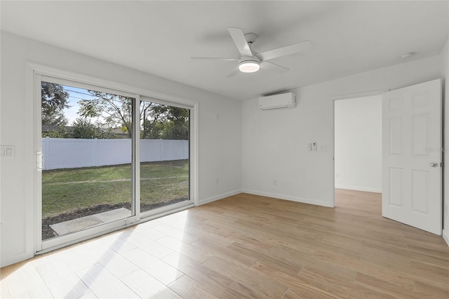 spare room with light hardwood / wood-style floors, an AC wall unit, and ceiling fan