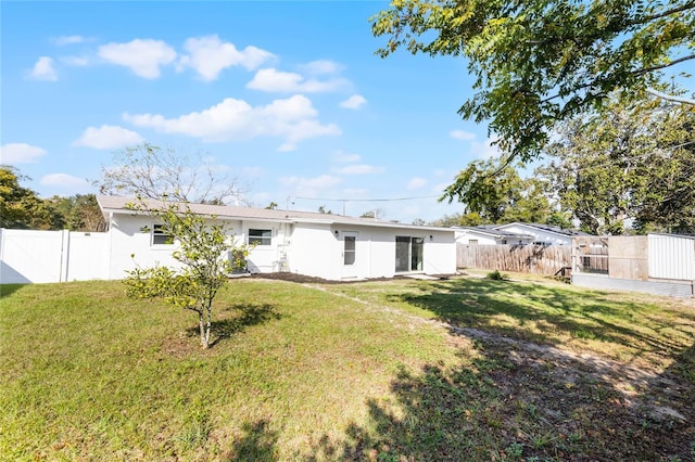 rear view of house with a lawn