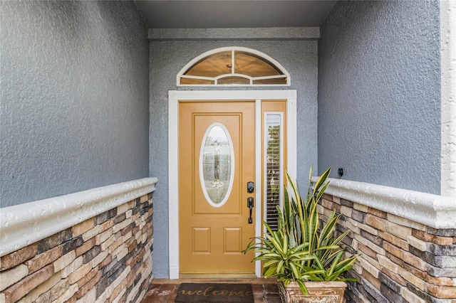 property entrance with stucco siding