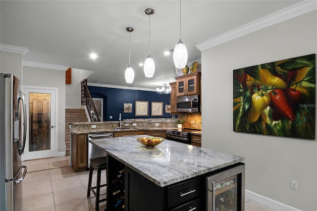 kitchen with beverage cooler, stainless steel appliances, light tile patterned floors, and a peninsula