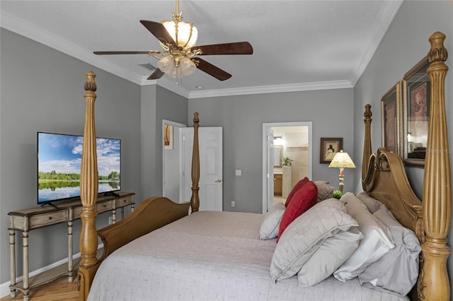 bedroom with crown molding, visible vents, ensuite bath, wood finished floors, and baseboards