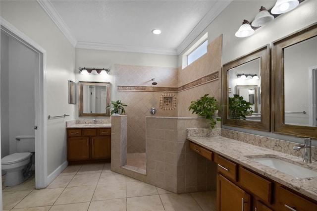 bathroom with toilet, tiled shower, tile patterned flooring, ornamental molding, and vanity