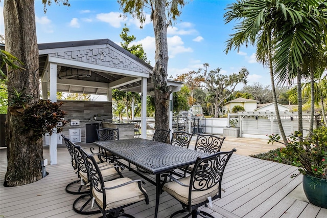 deck with a gazebo, outdoor dining space, fence, and area for grilling