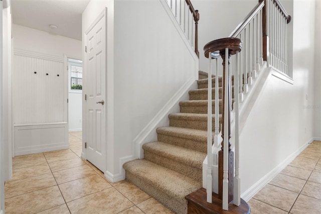 staircase featuring tile patterned floors