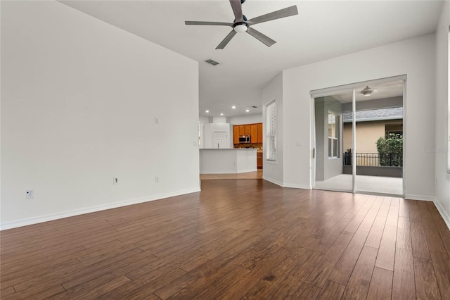 unfurnished living room featuring wood-type flooring and ceiling fan