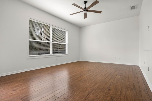 unfurnished room with dark hardwood / wood-style flooring and ceiling fan