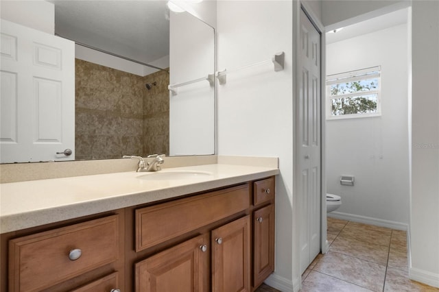 bathroom featuring tile patterned flooring, vanity, and toilet