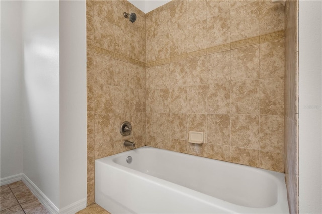 bathroom featuring tile patterned flooring and tiled shower / bath