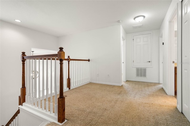 hallway featuring light colored carpet